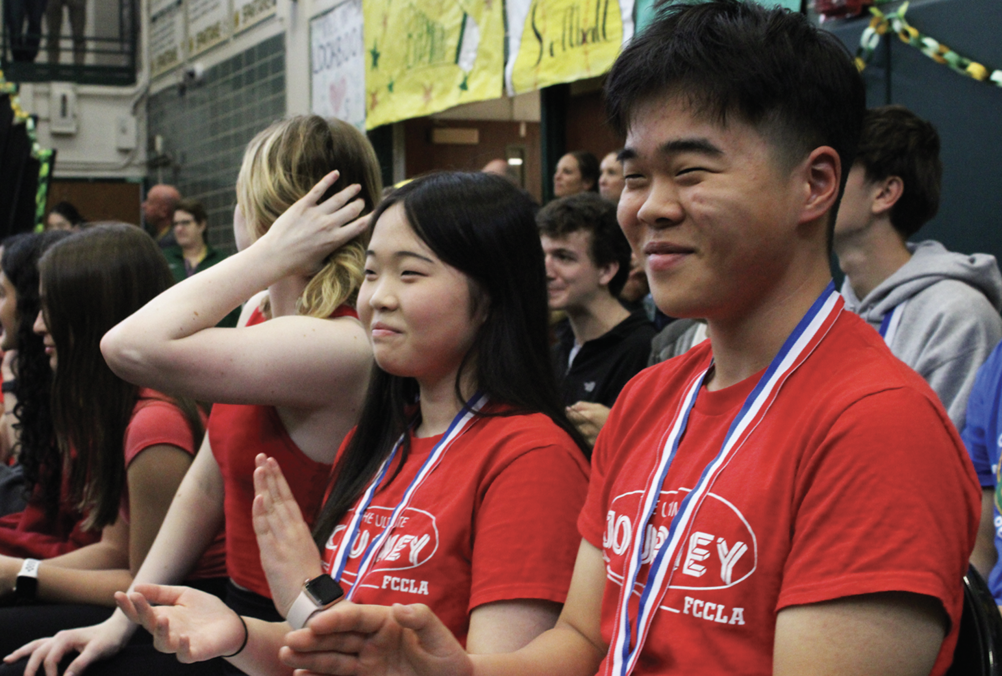 Juniors Jana Ahn and Jaden Ahn (foreground) sit alongside other FCCLA members at the Spartan Pride Assembly on April 25 while being recognized for their success at the state competition. The siblings placed first in the entrepreneurship category, qualifying them for the national competition.